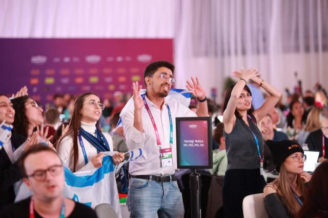 Israel fans cheer for their participant Israel's Noam Bettan at the press centre during the first semi-final of the Eurovision Song Contest (ESC) at Wiener Stadthalle in Vienna, Austria on May 12, 2026. (Photo by Radek MICA / AFP)