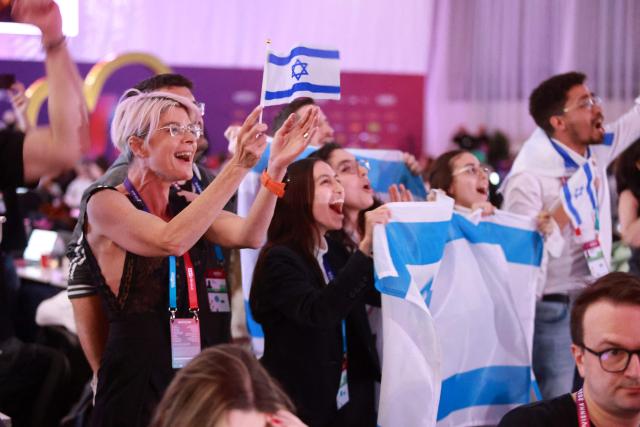 Israel fans cheer for their participant Israel's Noam Bettan at the press centre during the first semi-final of the Eurovision Song Contest (ESC) at Wiener Stadthalle in Vienna, Austria on May 12, 2026. (Photo by Radek MICA / AFP)