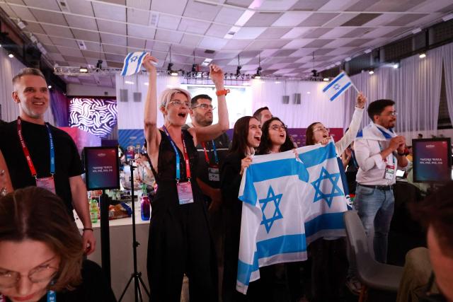 Israel fans cheer for their participant Israel's Noam Bettan at the press centre during the first semi-final of the Eurovision Song Contest (ESC) at Wiener Stadthalle in Vienna, Austria on May 12, 2026. (Photo by Radek MICA / AFP)