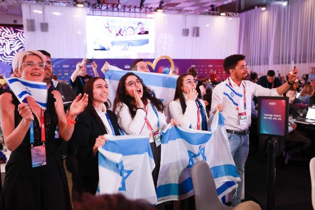 Israel fans cheer for their participant Israel's Noam Bettan at the press centre during the first semi-final of the Eurovision Song Contest (ESC) at Wiener Stadthalle in Vienna, Austria on May 12, 2026. (Photo by Radek MICA / AFP)
