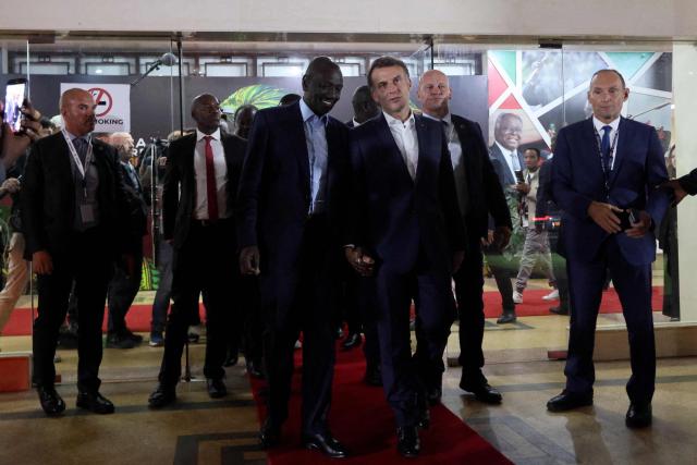 Kenya's President William Ruto (L) walks with France's President Emmanuel Macron at the end of their bilateral meeting at the Africa Forward summit in Nairobi on May 12, 2026. (Photo by Ludovic MARIN / AFP)