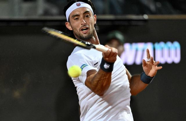 Argentina's Thiago Agustin Tirante hits a return to Russia's Daniil Medvedev during the ATP Rome Open tennis tournament at Foro Italico in Rome on May 12, 2026. (Photo by Tiziana FABI / AFP)