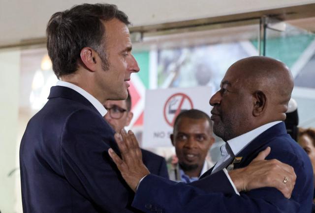 France's President Emmanuel Macron (L) embraces Comoros' President Assoumani Azali at the end of their bilateral meeting during the Africa Forward summit in Nairobi on May 12, 2026. (Photo by Ludovic MARIN / AFP)