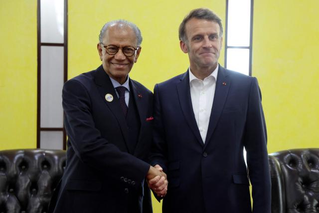France's President Emmanuel Macron (R) shakes hands with Mauritius' Prime Minister Navin Ramgoolam during their bilateral meeting during the Africa Forward summit in Nairobi on May 12, 2026. (Photo by Ludovic MARIN / AFP)