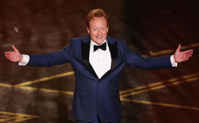 (FILES) US comedian and host Conan O'Brien speaks onstage during the 98th Annual Academy Awards at the Dolby Theatre in Hollywood, California on March 15, 2026. Comedian Conan O'Brien will return for the third straight time to host the Oscars in 2027, organizers announced on May 12, 2026. O'Brien, 63, will preside over the 99th edition of American cinema's most prestigious gala, which will be held on March 14 in the heart of Hollywood. (Photo by Patrick T. Fallon / AFP)