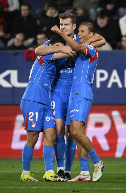 Atletico Madrid's Norwegian forward #09 Alexander Sorloth celebrates scoring his team's second goal with teammates during the Spanish league football match between CA Osasuna and Club Atletico de Madrid at El Sadar Stadium in Pamplona on May 12, 2026. (Photo by ANDER GILLENEA / AFP)