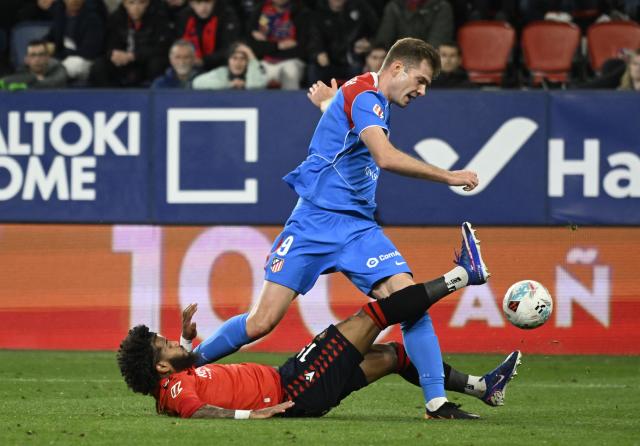 Atletico Madrid's Norwegian forward #09 Alexander Sorloth fights for the ball with Osasuna's French defender #19 Valentin Rosier (down) during the Spanish league football match between CA Osasuna and Club Atletico de Madrid at El Sadar Stadium in Pamplona on May 12, 2026. (Photo by ANDER GILLENEA / AFP)