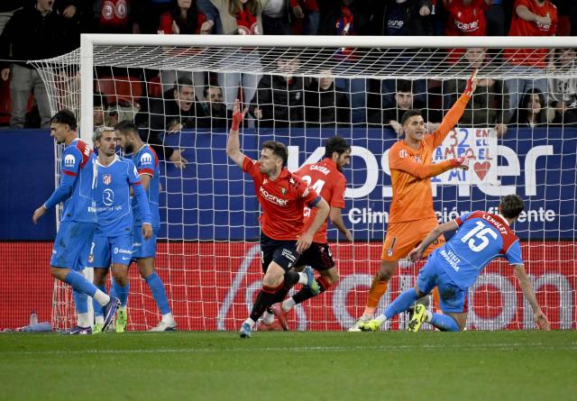 Osasuna's Spanish forward #11 Kike Barja (C) celebrates scoring his team's first goal during the Spanish league football match between CA Osasuna and Club Atletico de Madrid at El Sadar Stadium in Pamplona on May 12, 2026. (Photo by ANDER GILLENEA / AFP)