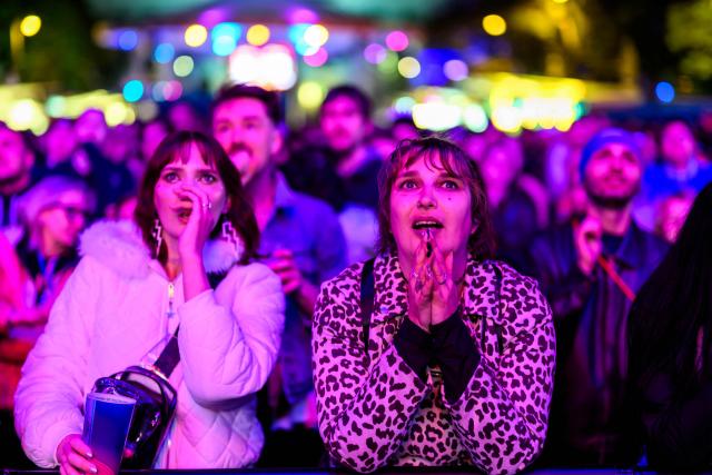 Spectators react at the fan area at City Hall Square (Rathausplatz) during the first semi-final of the Eurovision Song Contest (ESC) in Vienna, Austria on May 12, 2026. (Photo by MAX SLOVENCIK / APA / AFP) / Austria OUT