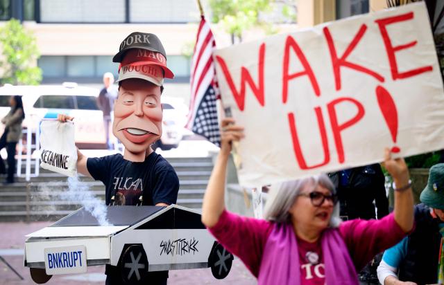 AI protesters chant outside the federal courthouse during proceedings in the trial of Elon Musk VS. OpenAI in Oakland, California, on May 12, 2026. Musk, the founder of Tesla and SpaceX, alleges that Altman and co-founder Greg Brockman misappropriated his $38 million donations when OpenAI abandoned its original nonprofit and philanthropic mission to become the for-profit giant behind ChatGPT. (Photo by JOSH EDELSON / AFP)