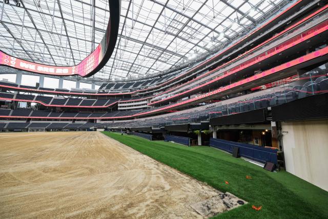 An expanded pitch surface area, which required the removal of corner seating and a raised custom field platform, awaits the installation of grass during the 30 Days to FIFA World Cup 2026 media event at SoFI Stadium before the pitch installation and temporary renaming to Los Angeles Stadium in Inglewood, California on May 12, 2026. The US Men's National Team will play their first 2026 FIFA World Cup match on June 12 against Paraguay. (Photo by Patrick T. Fallon / AFP)