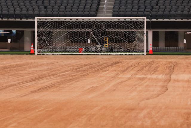 An expanded pitch surface area, which required the removal of corner seating and a raised custom field platform, awaits the installation of grass during the 30 Days to FIFA World Cup 2026 media event at SoFI Stadium before the pitch installation and temporary renaming to Los Angeles Stadium in Inglewood, California on May 12, 2026. The US Men's National Team will play their first 2026 FIFA World Cup match on June 12 against Paraguay. (Photo by Patrick T. Fallon / AFP)
