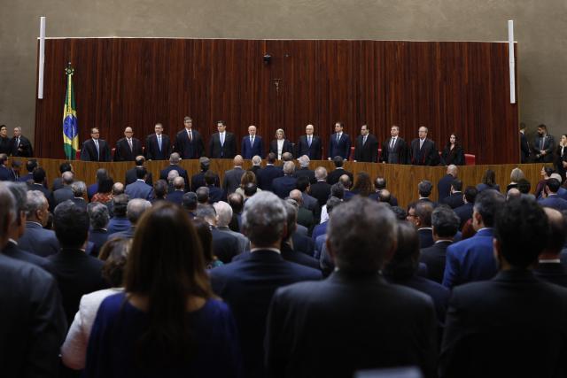 Brazil's President Luiz Inacio Lula da Silva (C) and Judge Nunes Marques, President of the Superior Electoral Court (TSE) (3nd L), attend Nunes's swearing-in ceremony in Brasilia on May 12, 2026. (Photo by Sergio LIMA / AFP)