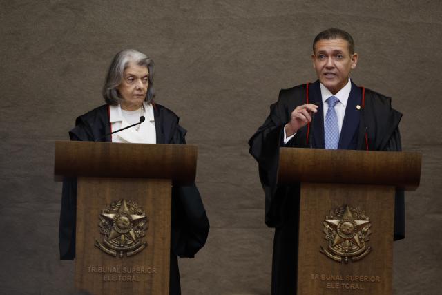 Judge Nunes Marques, President of the Superior Electoral Court (TSE), speaks next to outgoing President of the Superior Electoral Court, Minister Carmen Lucia, during Nunes's swearing-in ceremony in Brasilia on May 12, 2026. (Photo by Sergio LIMA / AFP)