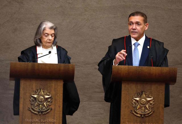 Judge Nunes Marques, President of the Superior Electoral Court (TSE), speaks next to outgoing President of the Superior Electoral Court, Minister Carmen Lucia, during Nunes's swearing-in ceremony in Brasilia on May 12, 2026. (Photo by Sergio LIMA / AFP)