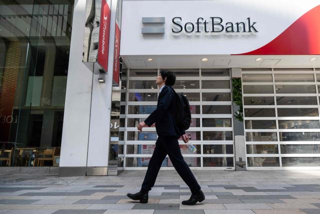 A man walks past a Softbank store in Tokyo on May 13, 2026. (Photo by Andrew CABALLERO-REYNOLDS / AFP)
