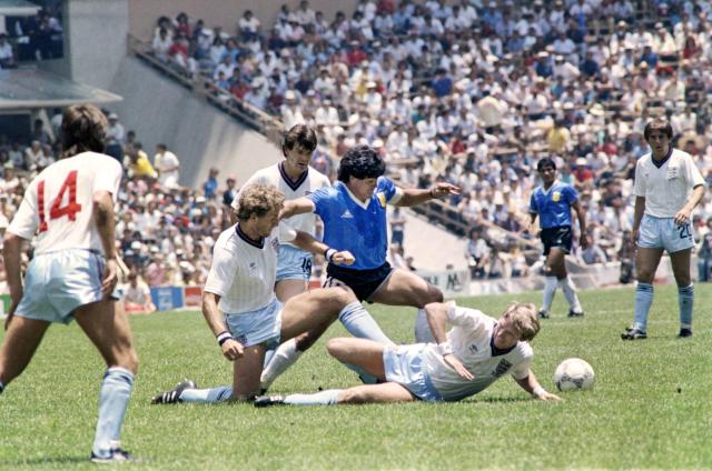 (FILES) Argentinian midfielder Diego Maradona (C) dribbles past three English defenders on June 22, 1986 in Mexico City during the World Cup quarterfinal soccer match between Argentina and England. Diego Armando Maradona. That name sums up the 1986 World Cup. "El Pelusa", a hero at Napoli, managed to lead a much-criticised Argentina – a team that had struggled immensely to qualify – to ultimate victory. (Photo by AFP)