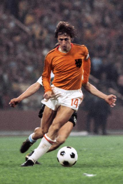 (FILES) Dutch forward Johan Cruyff controls the ball under pressure from a West German player during the World Cup quarterfinal soccer match between the Netherlands and Argentina on June, 26, 1974 in Gelsenkirchen. FIFA, under its new president, the Brazilian Joao Havelange, decided to make use of the infrastructure from the 1972 Munich Olympic Games and selected the Federal Republic of Germany to host the 1974 tournament. The Netherlands were the big surprise. They astonished everyone with their "total football", a revolution in which all players attacked and defended in the style of Ajax Amsterdam, who were dominating European football at the time. At the helm of this formidable team was Johan Cruyff. (Photo by AFP)