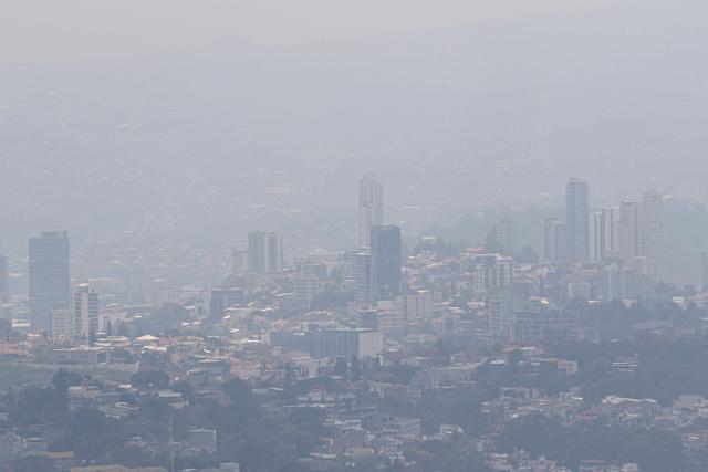 Haze covers the city during a heatwave in Tegucigalpa City on May 12, 2026. Honduras has decided to shorten the school-day and hold virtual classes due to the high temperatures that could intensify due to El Nino phenomenon, official sources reported. (Photo by Johny MAGALLANES / AFP)