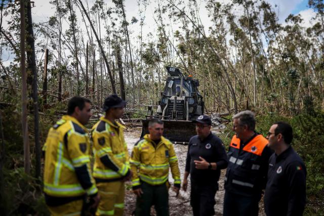A military tractor clears paths in a eucalyptus trees forest at Marinha Grande, central Portugal, on May 7, 2026. In a forest in central Portugal, the whirring of chainsaws sets the pace for the teams working to clear paths blocked by thousands of trees felled during the storms earlier this year, in a race against time as fire season approaches. Using heavy machinery, forestry workers and military personnel coordinate to push the felled trunks to the sides of the paths to reopen access to the Marinha Grande forest, which is essential for the rapid intervention of emergency services. (Photo by PATRICIA DE MELO MOREIRA / AFP) / TO GO WITH STORY BY LEVI FERNANDES