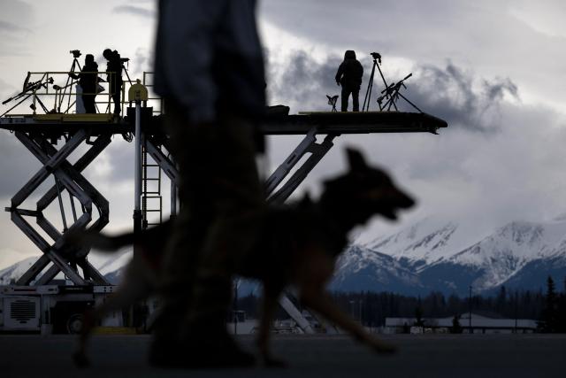 Counter snipers and other security forces watch over Air Force One while refueling at Joint Base Elmendorf during a trip with US President Donald J. Trump in Anchorage, Alaska, on May 12, 2026. Donald Trump was due in Beijing on May 13, 2026 on the first visit to China by a US president in nearly a decade, as he seeks to ramp up trade despite potential friction over Taiwan and Iran. (Photo by Brendan Smialowski / AFP)