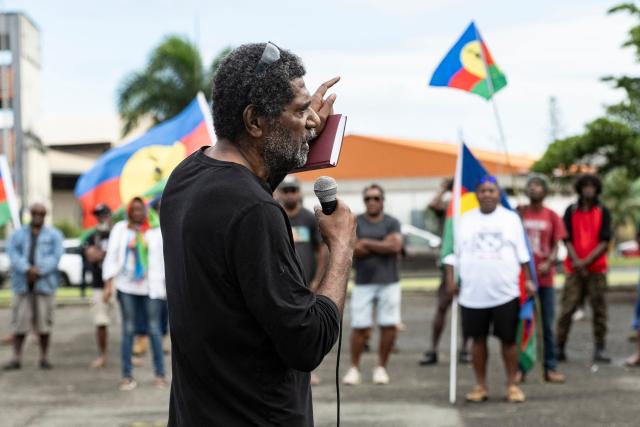Desire Tein, brother of pro-independence activist Christian Tein, addresses the crowd during a demonstration to mark the second anniversary of the spring 2024 riots in Noumea, in the French overseas collectivity of New Caledonia, on May 13, 2026. Two years after the violence that left 14 dead and caused several billion euros’ worth of damage in New Caledonia, tensions and mistrust remain, as the debate over the electoral roll, which sparked the insurrectional crisis, is still unresolved. (Photo by Delphine MAYEUR / AFP)