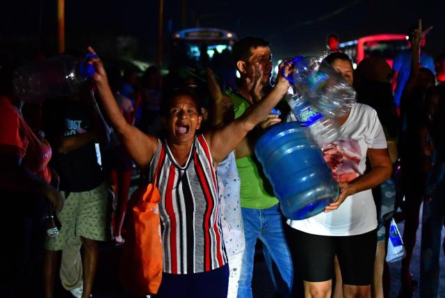A woman shouts slogans as residents of City Plaza neighborhood protest the lack of electricity and water in Valencia, Venezuela on May 12, 2026. (Photo by Jacinto Oliveros str / AFP)