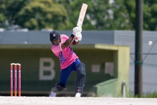 In this photo taken on May 9, 2026, Japans Esam Rahman plays a shot against Vanuatu during their ICC T20 World Cup East Asia-Pacific Qualifier cricket match at the Nisshin Cricket Ground at Korogi Sports Park in Nisshin, Aichi Prefecture. Curious spectators clutching rulebooks watch as a batsman smacks a six into the sand and weeds surrounding Japan's brand-new cricket ground, four months before it hosts matches at the Asian Games. (Photo by Andrew CABALLERO-REYNOLDS / AFP) / To go with 'ASIAD-2026-CRICKET-JPN,FOCUS' by Andrew MCKIRDY