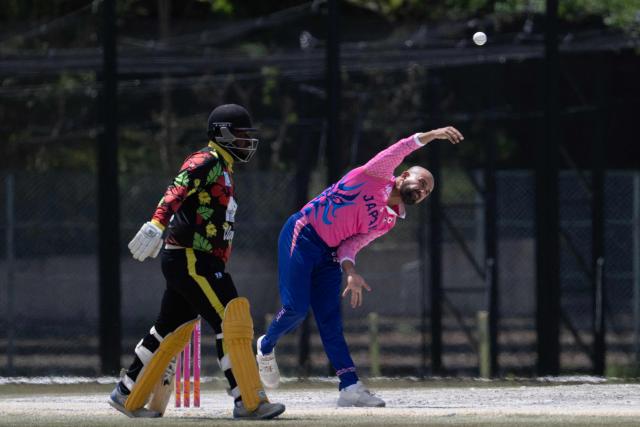 In this photo taken on May 9, 2026, Japans Ibrahim Takahashi (R) bowls during the ICC T20 World Cup East Asia-Pacific Qualifier cricket match between Japan and Vanuatu at the Nisshin Cricket Ground at Korogi Sports Park in Nisshin, Aichi Prefecture. Curious spectators clutching rulebooks watch as a batsman smacks a six into the sand and weeds surrounding Japan's brand-new cricket ground, four months before it hosts matches at the Asian Games. (Photo by Andrew CABALLERO-REYNOLDS / AFP) / To go with 'ASIAD-2026-CRICKET-JPN,FOCUS' by Andrew MCKIRDY