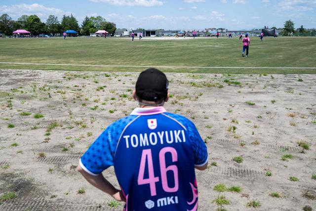 In this photo taken on May 9, 2026, a spectator watches the game during the ICC T20 World Cup East Asia-Pacific Qualifier match between Japan and Vanuatu at the Nisshin Cricket Ground at Korogi Sports Park in Nisshin, Aichi Prefecture. Curious spectators clutching rulebooks watch as a batsman smacks a six into the sand and weeds surrounding Japan's brand-new cricket ground, four months before it hosts matches at the Asian Games. (Photo by Andrew CABALLERO-REYNOLDS / AFP) / To go with 'ASIAD-2026-CRICKET-JPN,FOCUS' by Andrew MCKIRDY