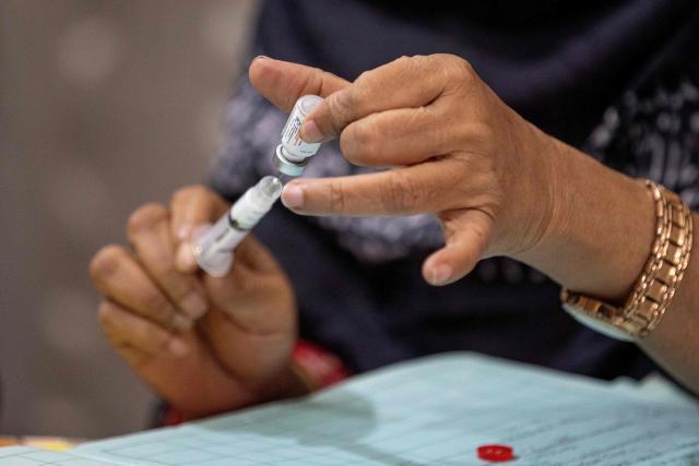 This photograph taken on April 27, 2026 shows Tahmina, a family welfare officer preparing a birth control injection at the Savar Upazila Health Complex in Dhaka. Bangladesh's once-praised family planning system is buckling under severe contraceptive shortages, raising fears of a rise in unplanned pregnancies in one of the world's most densely populated countries. (Photo by Salahuddin Ahmed / AFP)