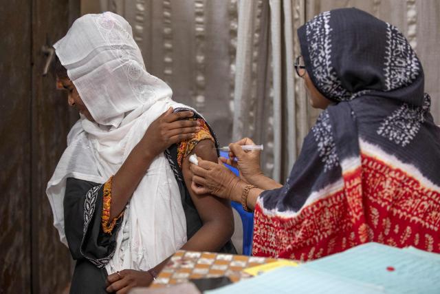 This photograph taken on April 27, 2026 shows Tahmina (R), a family welfare officer admistering a birth control injection to a woman at the Savar Upazila Health Complex in Dhaka. Bangladesh's once-praised family planning system is buckling under severe contraceptive shortages, raising fears of a rise in unplanned pregnancies in one of the world's most densely populated countries. (Photo by Salahuddin Ahmed / AFP)