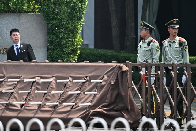 Chinese paramilitary police stand guard next to a hotel where US President Donald Trump is set to stay in Beijing on May 13, 2026, ahead of the US leader's arrival. (Photo by Hector RETAMAL / AFP)