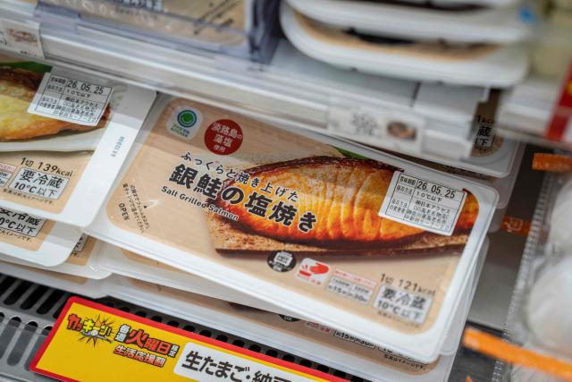 Packs of grilled salmon are on display at a FamilyMart convenience store in Tokyo on May 13, 2026. (Photo by Yuichi YAMAZAKI / AFP)