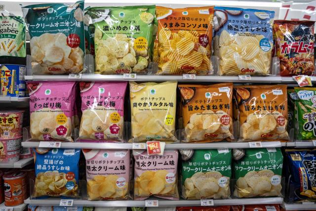 Bags of potato chips are on display at a FamilyMart convenience store in Tokyo on May 13, 2026. (Photo by Yuichi YAMAZAKI / AFP)