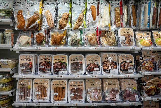 Packed foods including sausage and chicken are on display at a FamilyMart convenience store in Tokyo on May 13, 2026. (Photo by Yuichi YAMAZAKI / AFP)