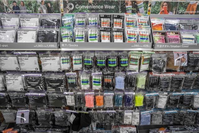 Items from FamilyMart’s original clothing brand Convenience Wear are displayed in a FamilyMart convenience store in Tokyo on May 13, 2026. (Photo by Yuichi YAMAZAKI / AFP)