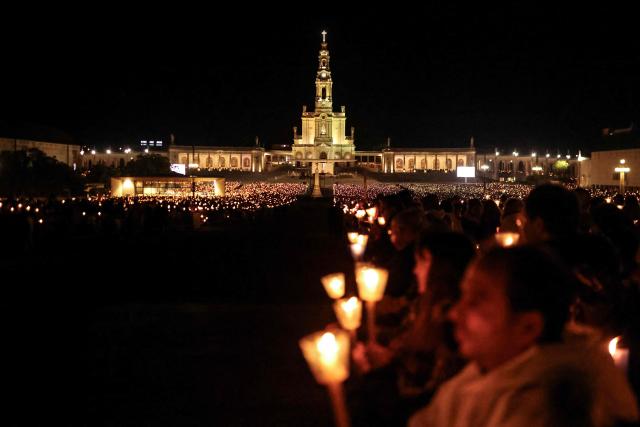 The Basilica of Our Lady of the Rosary is pictured during the candlelight procession at the Shrine of Fatima, central Portugal, late on May 12, 2026. Thousands of pilgrims converged on the Fatima Sanctuary to celebrate the anniversary of Fatima's miracle when three shepherd children claimed to have seen the Virgin Mary in May 1917. (Photo by PATRICIA DE MELO MOREIRA / AFP)