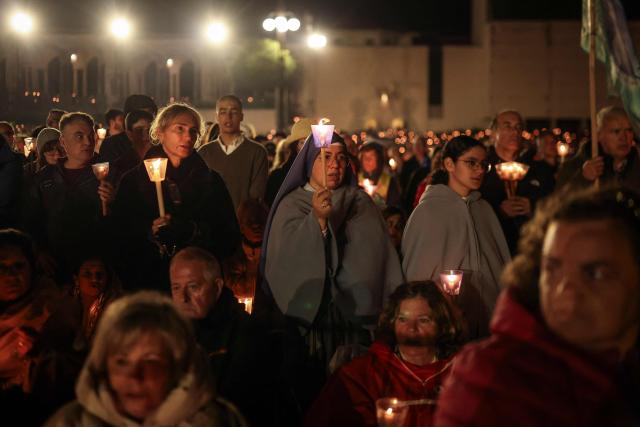 A nun holds a candle during the candlelight procession at the Shrine of Fatima, central Portugal, late on May 12, 2026. Thousands of pilgrims converged on the Fatima Sanctuary to celebrate the anniversary of Fatima's miracle when three shepherd children claimed to have seen the Virgin Mary in May 1917. (Photo by PATRICIA DE MELO MOREIRA / AFP)