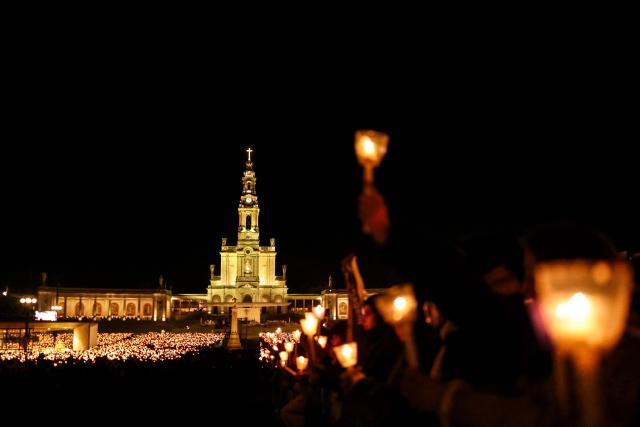 The Basilica of Our Lady of the Rosary is pictured during the candlelight procession at the Shrine of Fatima, central Portugal, late on May 12, 2026. Thousands of pilgrims converged on the Fatima Sanctuary to celebrate the anniversary of Fatima's miracle when three shepherd children claimed to have seen the Virgin Mary in May 1917. (Photo by PATRICIA DE MELO MOREIRA / AFP)