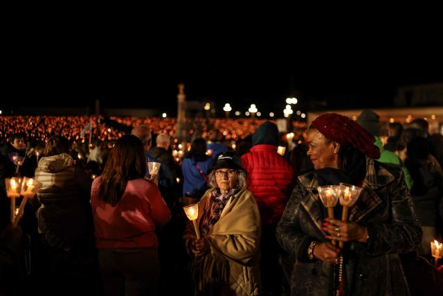 Pilgrims take part in the candlelight procession at the Shrine of Fatima, central Portugal, late on May 12, 2026. Thousands of pilgrims converged on the Fatima Sanctuary to celebrate the anniversary of Fatima's miracle when three shepherd children claimed to have seen the Virgin Mary in May 1917. (Photo by PATRICIA DE MELO MOREIRA / AFP)