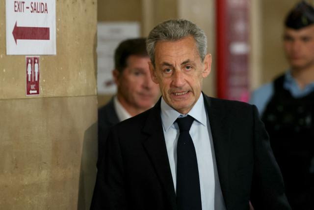 France's former president Nicolas Sarkozy arrives for his appeal trial over charges he had sought Libyan financing for his 2007 election in exchange for helping improve Tripoli's image after deadly bombing, at the Palais de Justice courthouse in Paris on May 13, 2026. Nearly two months after the start of the appeal trial regarding allegations of Libyan funding of Nicolas Sarkozy's 2007 presidential campaign, the public prosecutor's office is due to announce on May 13, 2026, the sentences it is seeking against Nicolas Sarkozy and his nine co-defendants, in this case that has already seen the former head of state serve time in prison. (Photo by Alain JOCARD / AFP)