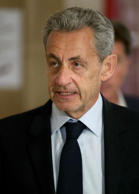 France's former president Nicolas Sarkozy arrives for his appeal trial over charges he had sought Libyan financing for his 2007 election in exchange for helping improve Tripoli's image after deadly bombing, at the Palais de Justice courthouse in Paris on May 13, 2026. Nearly two months after the start of the appeal trial regarding allegations of Libyan funding of Nicolas Sarkozy's 2007 presidential campaign, the public prosecutor's office is due to announce on May 13, 2026, the sentences it is seeking against Nicolas Sarkozy and his nine co-defendants, in this case that has already seen the former head of state serve time in prison. (Photo by Alain JOCARD / AFP)