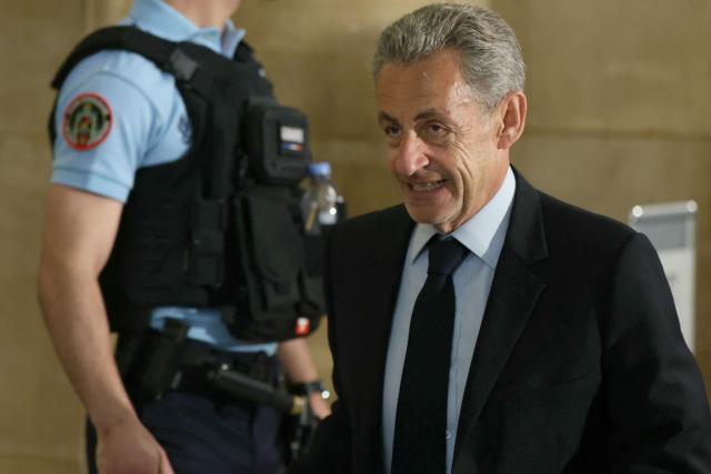 France's former president Nicolas Sarkozy arrives for his appeal trial over charges he had sought Libyan financing for his 2007 election in exchange for helping improve Tripoli's image after deadly bombing, at the Palais de Justice courthouse in Paris on May 13, 2026. Nearly two months after the start of the appeal trial regarding allegations of Libyan funding of Nicolas Sarkozy's 2007 presidential campaign, the public prosecutor's office is due to announce on May 13, 2026, the sentences it is seeking against Nicolas Sarkozy and his nine co-defendants, in this case that has already seen the former head of state serve time in prison. (Photo by Alain JOCARD / AFP)