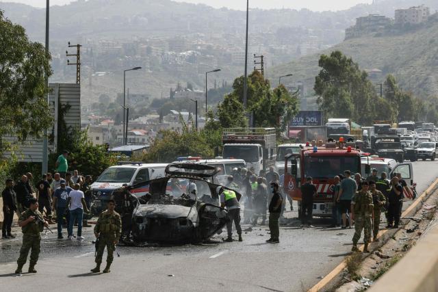 First responders work at the site of an Israeli drone strike that targeted a vehicle on a highway near the town of Jiyeh, south of Beirut, on May 13, 2026. Israeli strikes targeted two cars on May 13 on a major highway linking Beirut to southern Lebanon, state media reported, despite a truce in the war between Israel and Hezbollah. (Photo by MAHMOUD ZAYYAT / AFP)