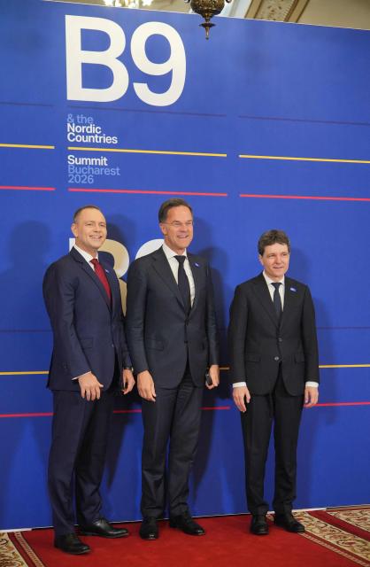 Romania's President Nicusor Dan (R) and Poland's President Karol Nawrocki (L) pose with NATO Secretary General Mark Rutte before attending the summit of the Bucharest Nine (B9) and the Nordic countries at the Cotroceni Palace in Bucharest, Romania on May 13, 2026. The event is co-chaired by the President of Romania and the President of Poland under the overarching theme of 'Delivering More for Transatlantic Security' and will focus on transatlantic security and NATOs forthcoming summit in Ankara. The B9 format, also known as NATO's Eastern Flank, includes Bulgaria, the Czech Republic, Estonia, Hungary, Latvia, Lithuania, Poland, Romania and Slovakia. (Photo by Mihai Barbu / AFP)