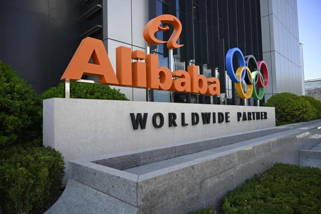 (FILES) A company logo is pictured during a tour at the Alibaba office in Beijing on April 1, 2026. Chinese tech behemoth Alibaba posted an 18 percent drop in net profit during its most recent fiscal year on May 13, 2026, weighed by challenges in the domestic economy and an expensive push into artificial intelligence. (Photo by WANG Zhao / AFP)