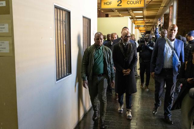 Vusimuzi “Cat” Matlala (C), suspected of links to organised crime, is escorted in handcuffs after appearing in court on charges linked to an irregular Medicare24 police tender, at the Pretoria Magistrate’s Court in Pretoria on May 13, 2026. (Photo by EMMANUEL CROSET / AFP)