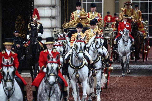 The carriage carrying Britain's King Charles III and Britain's Queen Camilla departs Buckingham Palace to attend the State Opening of Parliament, in London on May 13, 2026. (Photo by Henry NICHOLLS / AFP)