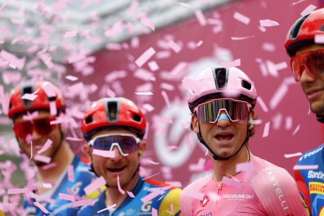 Lidl - Trek Italian rider Giulio Ciccone (2nd R) wearing the overall leader's pink jersey reacts on the podium as he arrives ahead of the 5th stage of the Giro d'Italia 2026 - Tour of Italy cycling race between Praia a Mare and Potenza, southern Italy on May 13, 2026. (Photo by Luca Bettini / AFP)